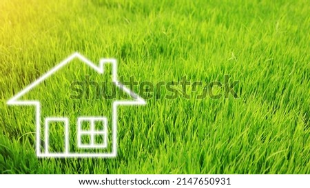 the home icon in the green grass field. House or real estate concept.