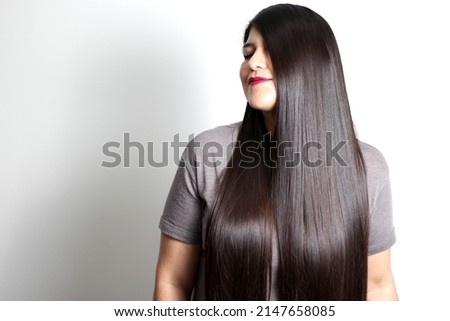Overweight Latin young adult woman shows how silky and shiny her black hair is, very long, straight, very happy and proud of the beautiful hair with a beautiful haircut
 Royalty-Free Stock Photo #2147658085