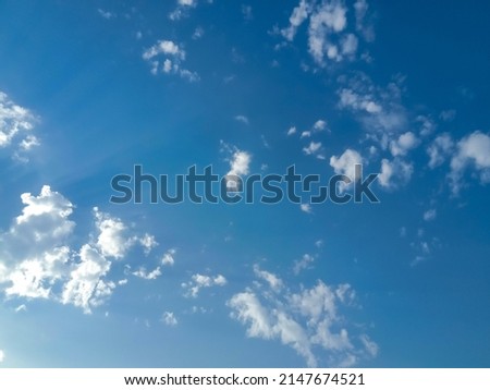 Beautiful white clouds on deep blue sky background. Elegant blue sky picture in daylight. Small thin soft white fluffy clouds in the blue sky background. Cumulus clouds in clear blue sky. No focus