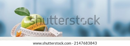 Apple and tape measure on the nutritionist desk, healthy diet and weight loss concept, banner with copy space Royalty-Free Stock Photo #2147683843