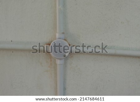 plastic pipe and four angle side pipe attached on the wall