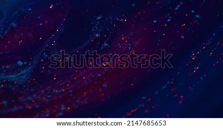 Fluorescent background. Blur sparks texture. Paint water mix. Defocused neon red glitter glow on dark blue purple color gradient abstract banner.