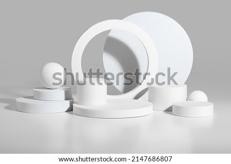 Abstract podium mockup of white cylinders and spheres on gray background Royalty-Free Stock Photo #2147686807