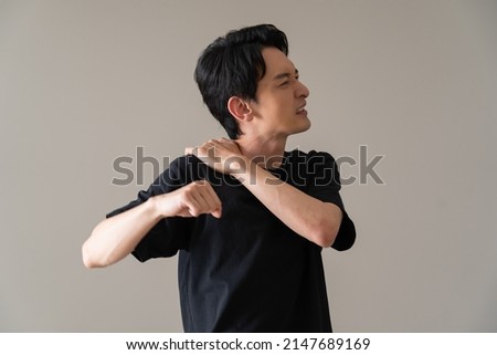 Japanese man complaining of neck pain Royalty-Free Stock Photo #2147689169