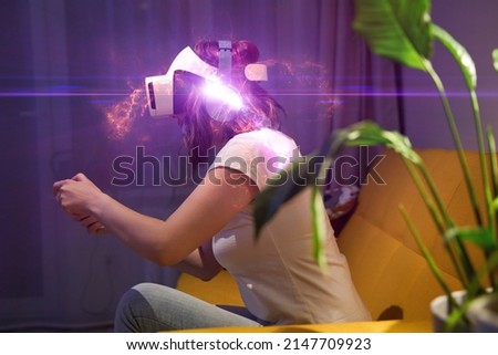 Woman with virtual reality headset and joystic is playing game. Elements image furnished by NASA.