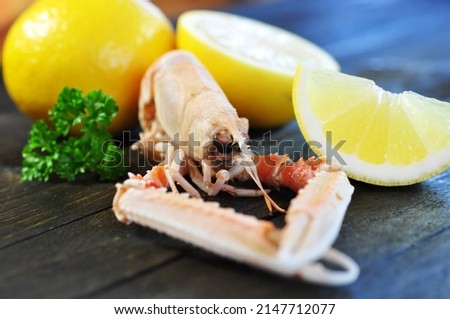 Seafood, prawn with lemon on wooden background, closeup.