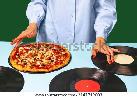 Cook or dj. Food pop art photography. Female hands with italian pizza lying on vinyl discs on light tablecloth isolated on green background. Vintage, retro style interior. Complementary colors,