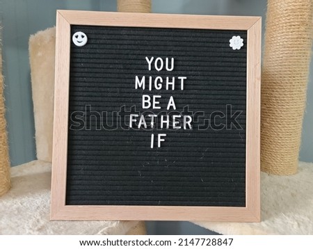 A sign saying you might be a father if. The felt sign has removable letters than can be moved around to make whatever words or saying one wants. 