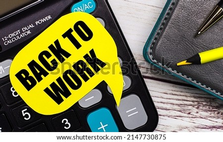 On a light wooden table, there is a calculator, a notebook, a pen, a yellow pencil, and a yellow card with the text BACK TO WORK. Business concept.