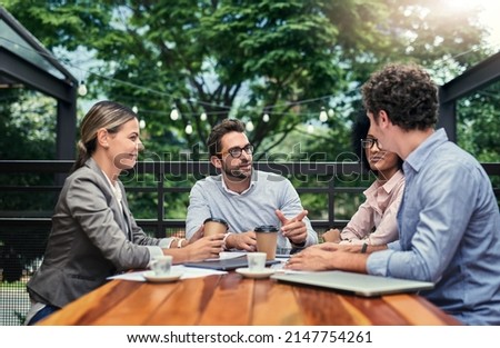Location, location, location. Cropped shot of a group of business colleagues having a meeting outdoors at a cafe. Royalty-Free Stock Photo #2147754261