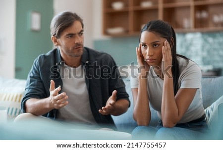dont want to talk right now. Shot of a young couple having an argument at home.