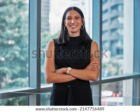 Work hard to become the best version of yourself. Portrait shot of a young businesswoman standing with her arms crossed at work. Royalty-Free Stock Photo #2147756489