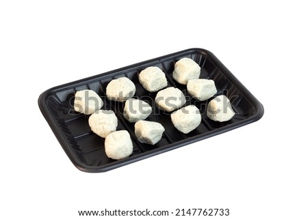 side view of round fish balls on a black plastic tray isolated on a white background
Buffet menu prepared for Sukiyaki and Shabu