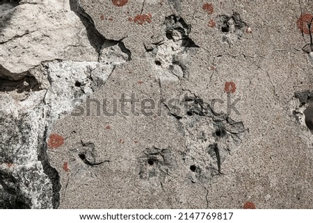 Damaged stone wall with bullet marks - sign of a war concept Royalty-Free Stock Photo #2147769817
