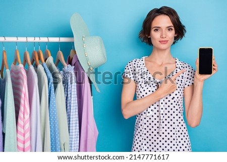 Photo of beautiful lady indicate finger empty space display notification app isolated on blue color background