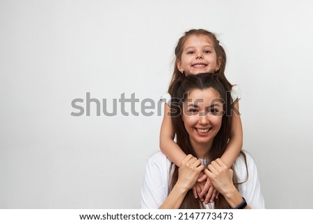 Happy woman and child girl 5-6 years old having fun