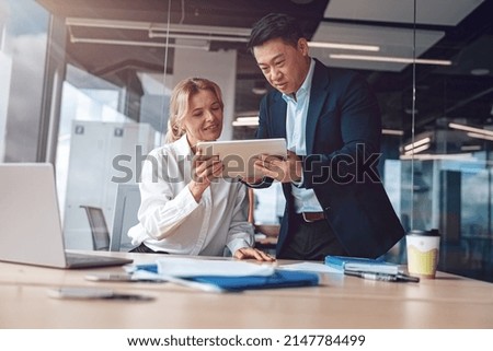excited happy emotional colleagues in office working with computer and tablet in modern office Royalty-Free Stock Photo #2147784499