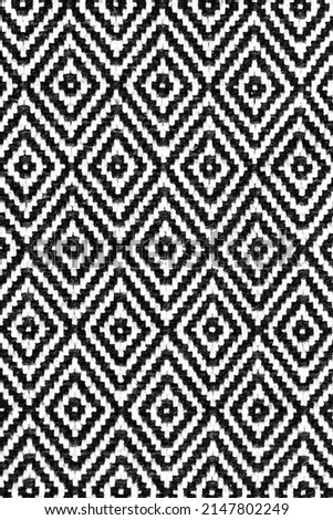 Rhombus - old ethnic canvas. Geometric ethnic pattern made with straw in black and white. knitting fabric pattern for background. Royalty-Free Stock Photo #2147802249