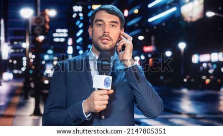 Anchorman Reporting Live News in a City at Night. News Coverage by Professional Handsome Reporter from a Business District. Journalist Presenting News for TV Channel. Newscaster Talking. Royalty-Free Stock Photo #2147805351