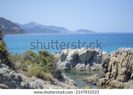 Beautiful view of the cliffs and clear water of the Corsican sea. Boat on the sea.