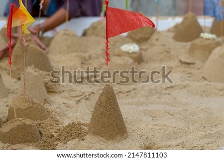 Sand pagoda in Songkran day on Thailand, The tradition of building a sand pagoda on Songkran Day is to return the sand fragments to temple in form of a sand pagoda and to offer it to Buddha Royalty-Free Stock Photo #2147811103