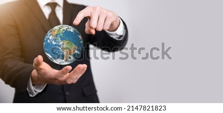 3D Earth planet globe in man, woman hand, hands on blue background. Environmental protection concept. Elements of this image furnished by NASA.