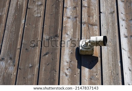 invigilator on the street. security camera on the wooden wall Royalty-Free Stock Photo #2147837143