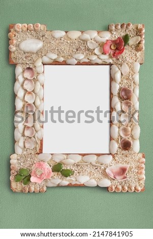 Empty vintage picture frame hanging on green wall