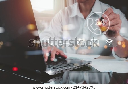 A guy indicates an operator's emblem, which includes iconography for after-sales services. Customer satisfaction communication channel Royalty-Free Stock Photo #2147842995