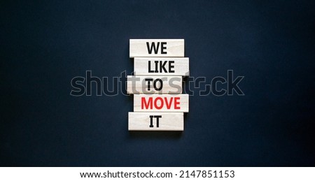 We like to move it symbol. Concept words We like to move it on wooden blocks. Beautiful black table black background. Business motivational We like to move it concept. Copy space.