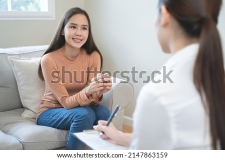 Mental health counselor. Young woman during therapy session talking with a psychologist in the office. Royalty-Free Stock Photo #2147863159