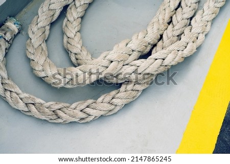 Nautical rope  on boat the grey floor. Close up. Nautical detail.