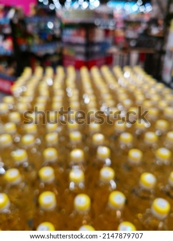 Blur picture of palm or olive oil in bottle pattern. Blur Supermarket sale oil bottles on shelves background, Many cooking vegetable oil bottles sale on the shelf in a supermarket.