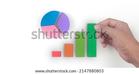 Business connecting piece of multi colored pie  chart in a hand