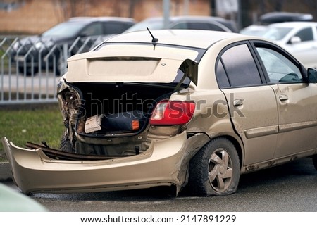 Traffic accident in the city. A car with a broken rear bumper on the road                                Royalty-Free Stock Photo #2147891229