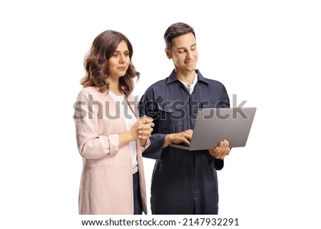 Young woman looking at a laptop computer with a male worker in a uniform isolated on white background