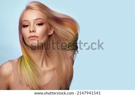 Beautiful woman with multi-colored hair and classic make up and hairstyle. Beauty face.