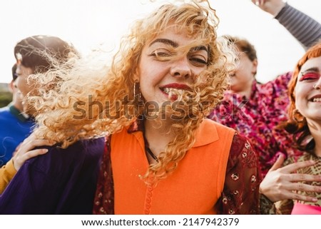 Happy young people dancing outdoor at festival event - Party and entertainment concept - Focus on center girl face Royalty-Free Stock Photo #2147942379