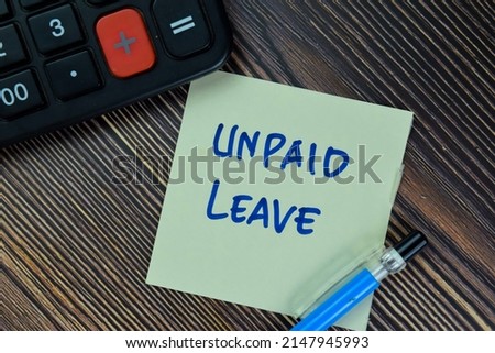 Unpaid Leave write on sticky notes isolated on Wooden Table. Royalty-Free Stock Photo #2147945993
