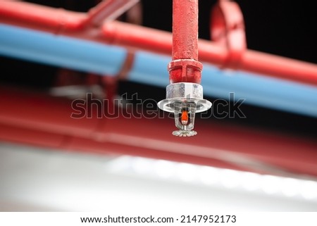 Fire sprinkler and red pipe. Royalty-Free Stock Photo #2147952173