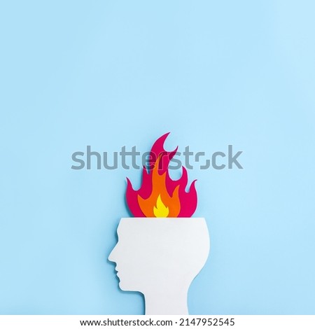 Cardboard application of the silhouette of human head and  flame. Minimal concept of psychological and emotional burnout. Square orientation, copy space