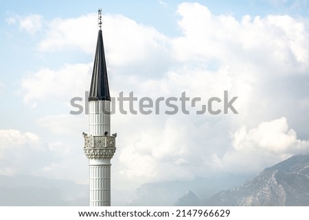 White mosque minaret. Mosque minaret with clouds in the background in Turkey Royalty-Free Stock Photo #2147966629