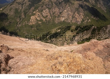 View of the rocky precipice, forest and steep mountains, from the top of the hill.  Royalty-Free Stock Photo #2147968931