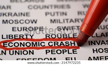 Closeup shot of ECONOMIC CRASH written on white paper with a red circle. Military activities. Sanctions. Crisis. Russian invasion of Ukraine concept. 