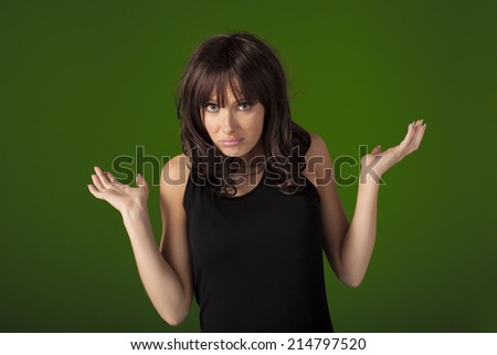 Young woman looking and feeling very confused over a green screen that can be replaced by any background.