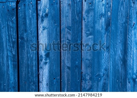 Wodden blue planks in various shades of colours, aged wodden wall of the cottage house surface making a good background material in royal blue color