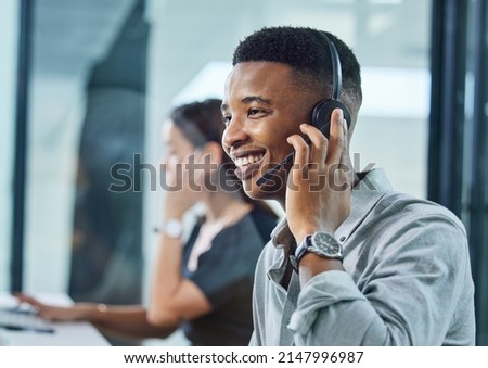 Im here to help you. Shot of a young call centre agent on a call in an office. Royalty-Free Stock Photo #2147996987