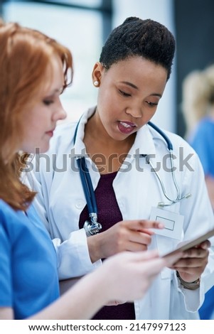Even doctors sometimes need a second opinion. Shot of two young doctors discussing a patients file. Royalty-Free Stock Photo #2147997123