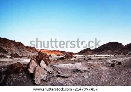 Its a vast and barren landscape. Shot of rugged desert terrain. Royalty-Free Stock Photo #2147997457