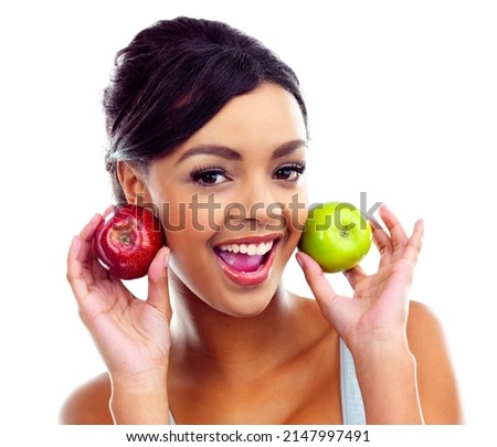 Shes into healthy eating. A young woman in gymwear holding two apples and smiling at the camera.
